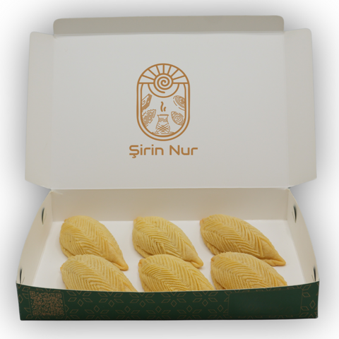 Azerbaijani Shekerbura – elegant crescent pastry with a sugar-nut filling, hand-pressed patterns and rich festive taste.